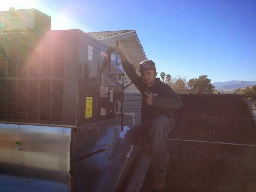 HVAC technician performing AC Tune-Up on a rooftop unit in Monrovia